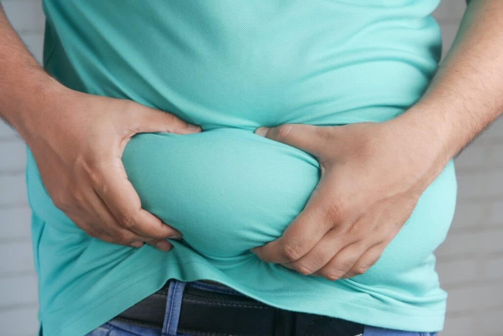 Image of guy holding belly fat