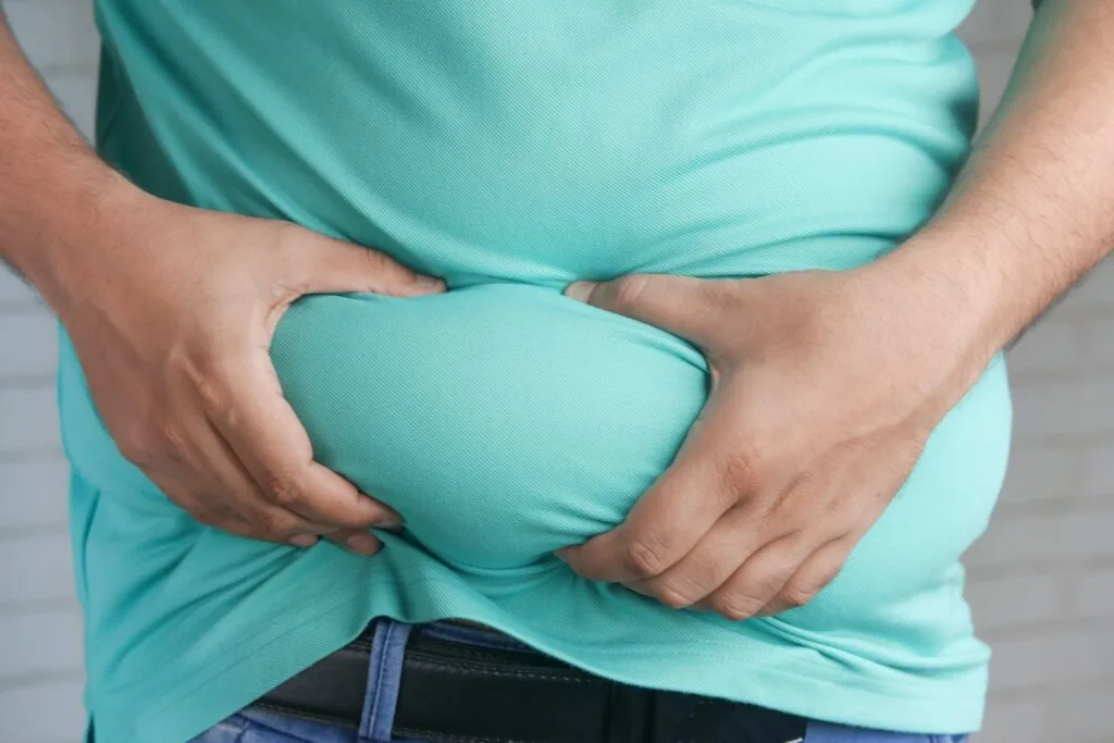 Image of guy holding belly fat